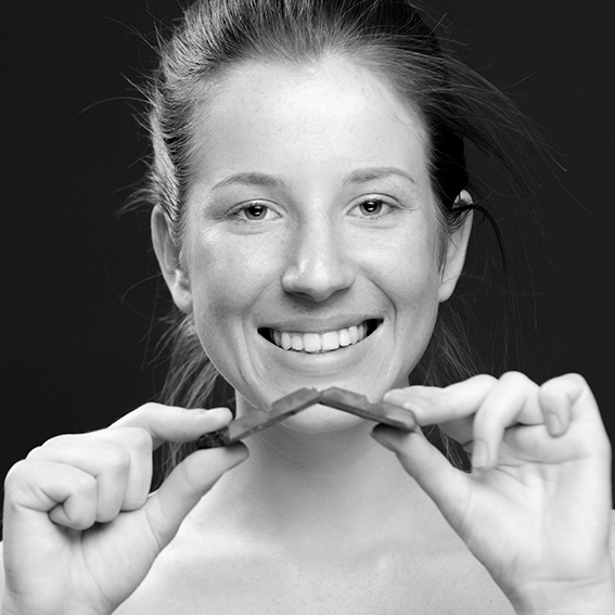 Smiling woman holding chocolate